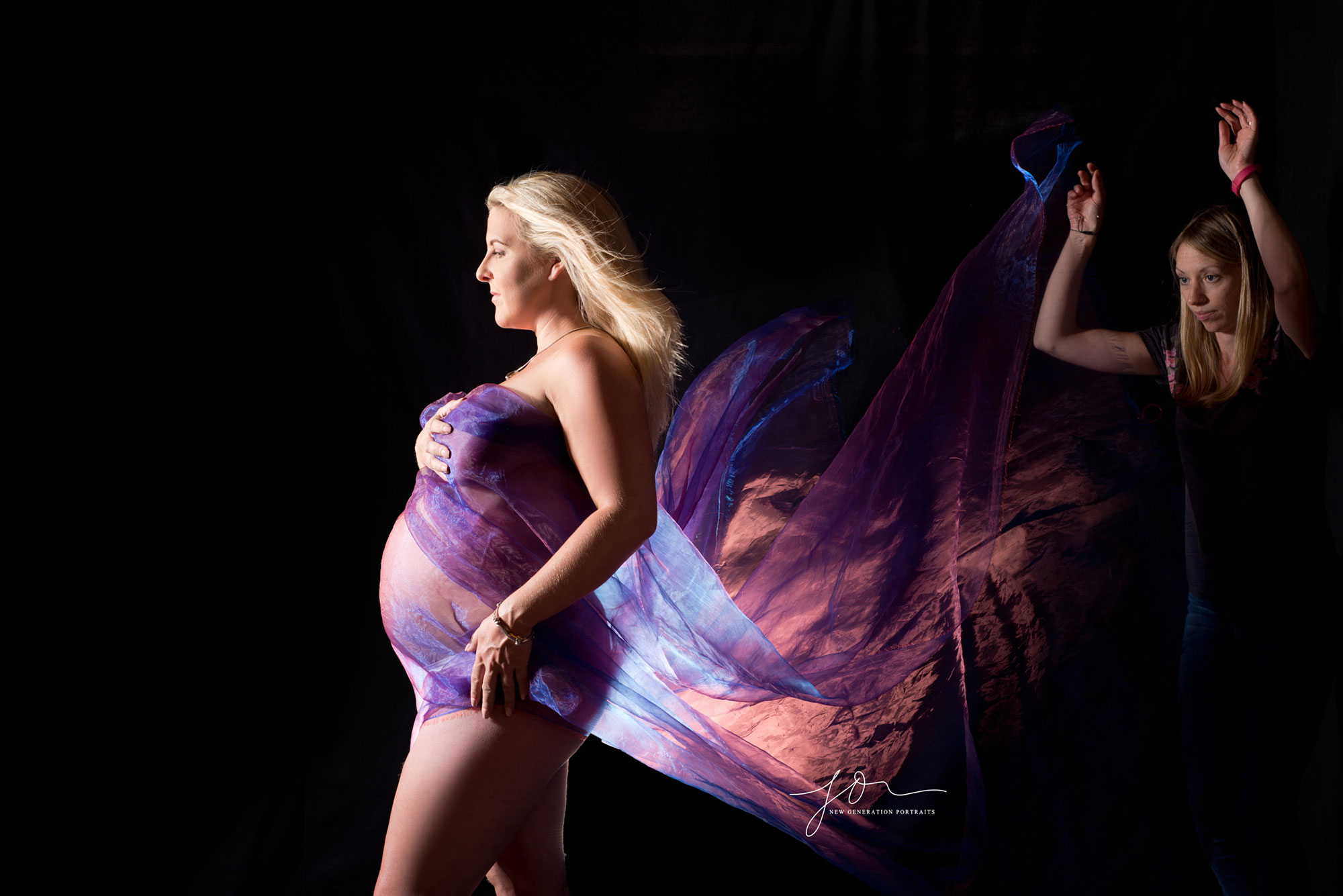 maternity behind the scenes throwing purple fabrics captured by New Generation Portraits Ltd