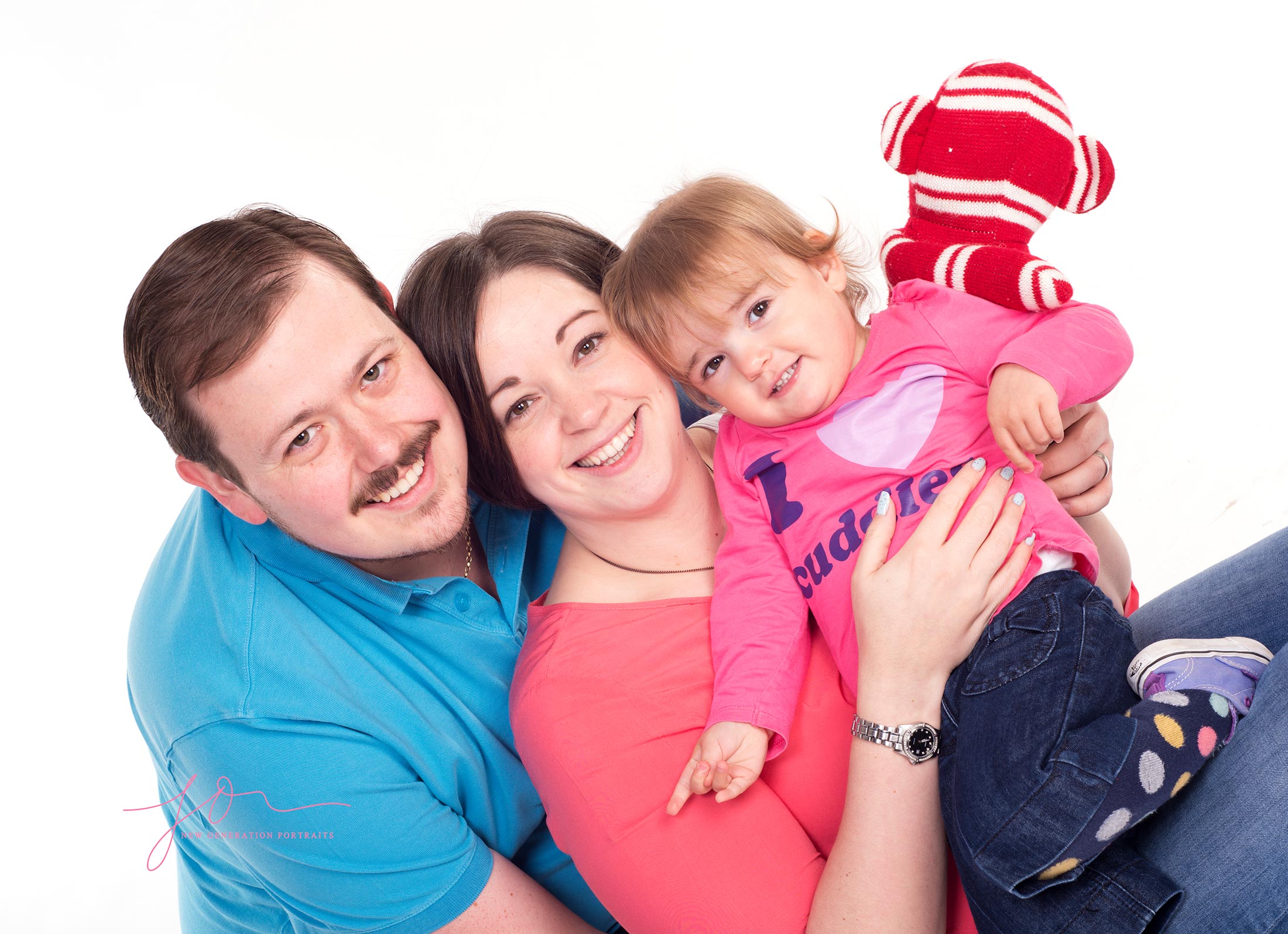Happo portrait of mum, dad and daughter in our white studio. Captured by New Generation Portraits Ltd
