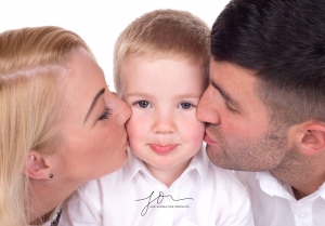 Mum and dad with their little boy in our Spital Studio Wirral. Captured by New Generation Portraits