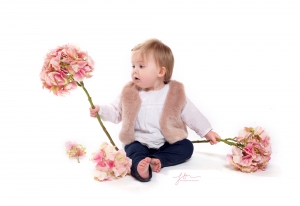 Your child playing with flowers in our studio. Captured by New Generation Portraits