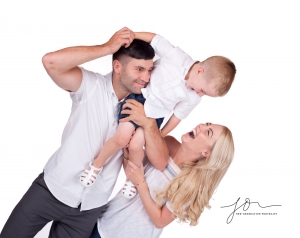 Fun Family portrait in our high key studio. Captured by New Generation Portraits.
