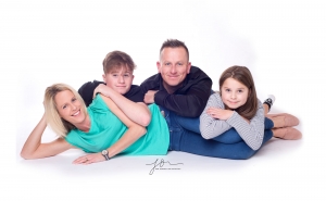 Fun bright family portraits all leaning on mum. Captured by New Generation Portraits