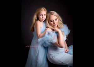 Portrait of mum and young daughter in our light blue gowns. Captured by New Generation Portraits.
