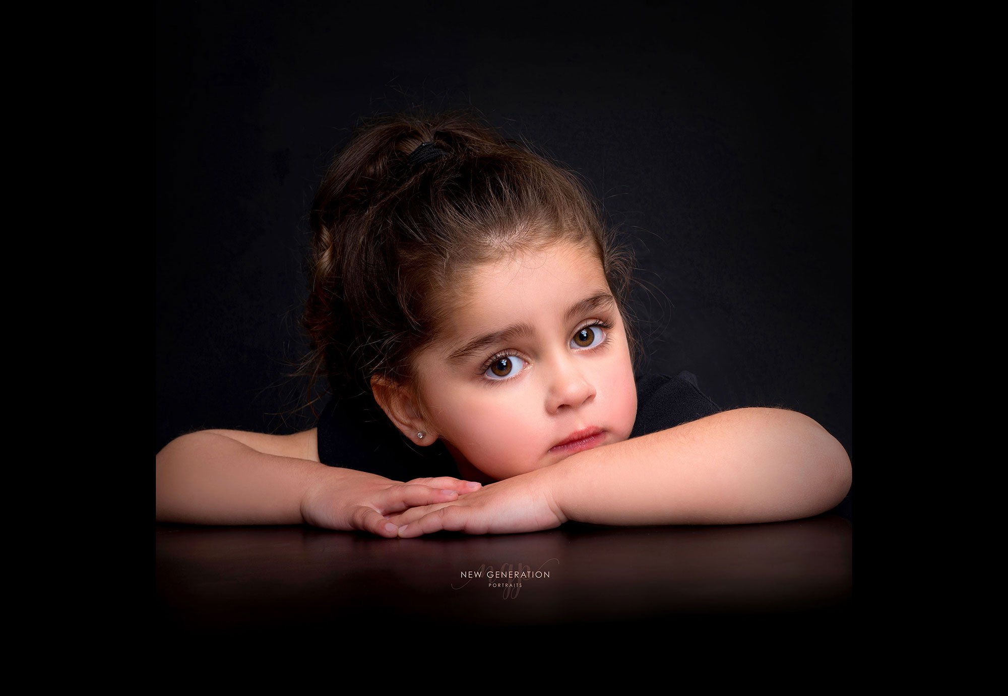 Child looking beautiful with large brown eyes captured by New Generation Portraits