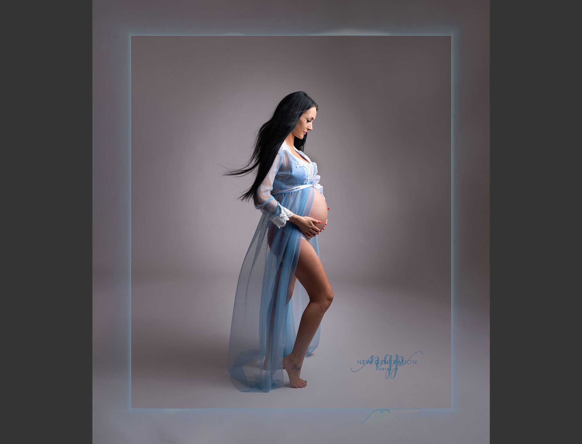 Side profile of pregnant mum in blue dress in our studio. Captured by New Generation Portraits