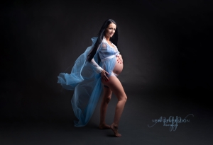 Maternity portrait of mum to be in blue dress. Captured by New Generation Portraits
