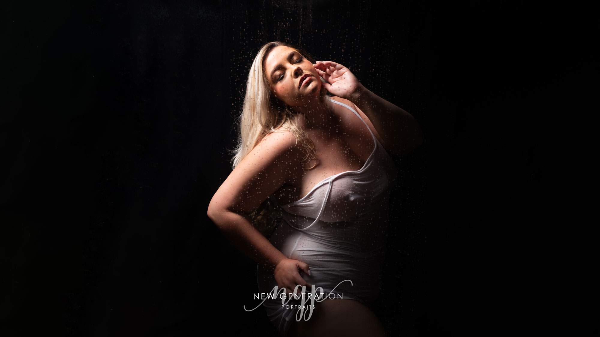 Lady in white dress in shower for boudoir shoot. Captured by New Generation Portraits